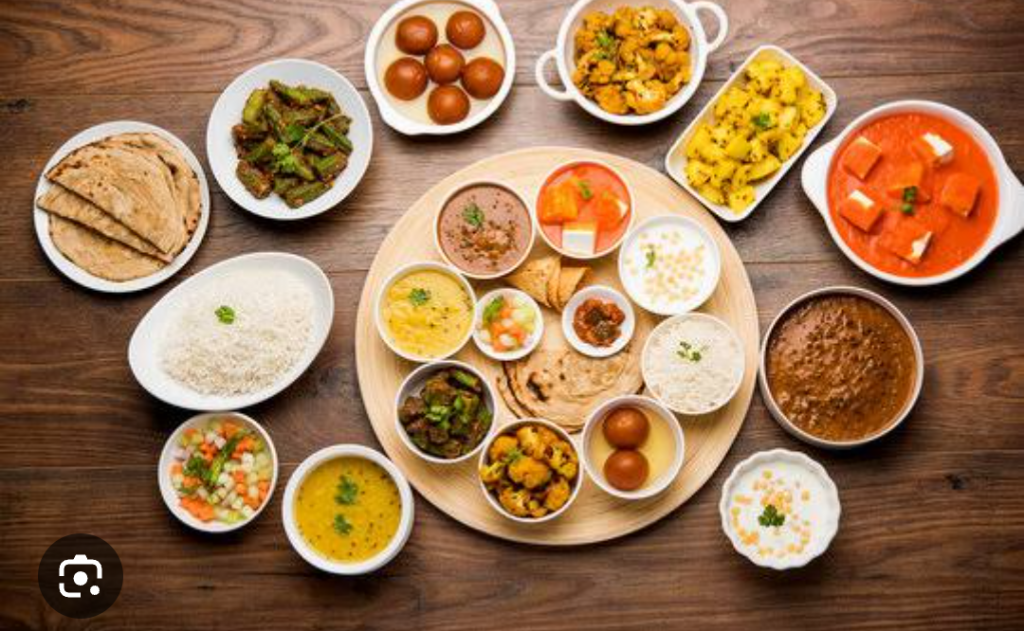 Assorted sushi, ramen, and dim sum on a wooden table, overlay ‘Pan-Asian Delights Pune’ and puneripages.in