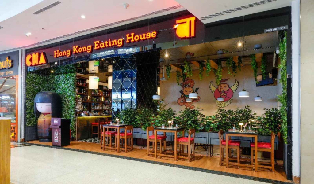 Interior of a busy restaurant at Phoenix Market City Pune with diners.