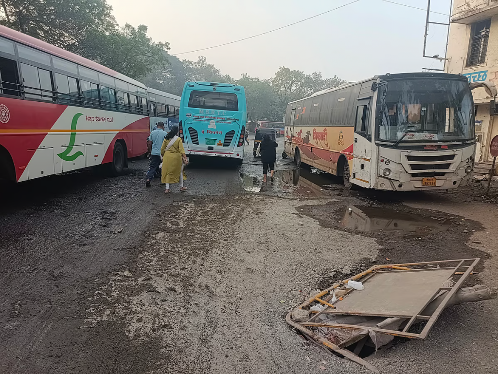 Flooded platform at Pune’s Swargate MSRTC bus depot with buses stationed amid slushy, waterlogged grounds