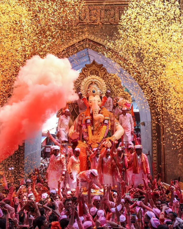 Devotees gathered under colorful paan-leaf canopies offering prayers to a clay Ganesh idol adorned with marigold garlands.