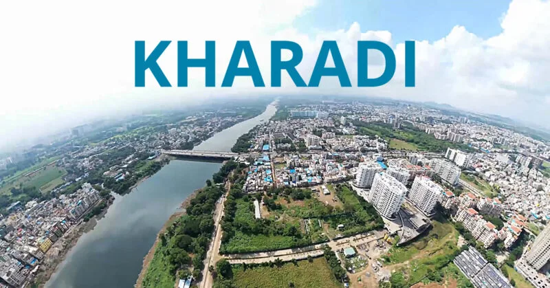 Street-level scene in Kharadi with modern IT office towers, busy roads, and emerging residential high-rises under development.