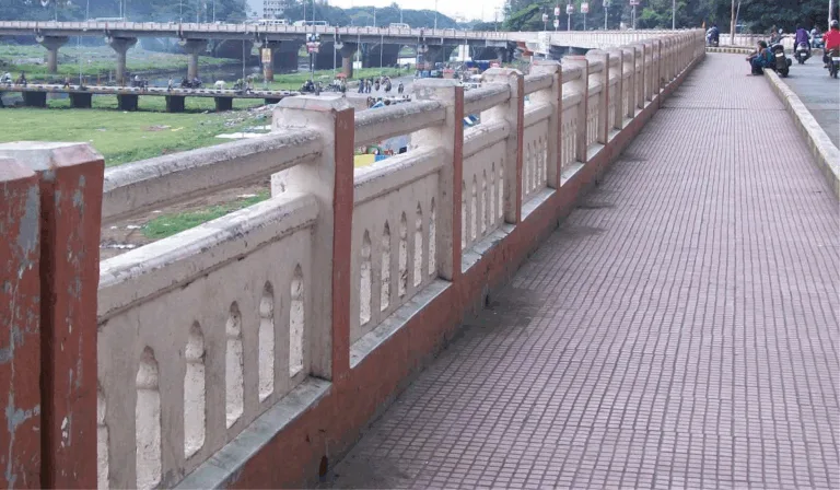 Illustrated green bridge connecting two city parks with people cycling and walking peacefully in Pimpri-Chinchwad.