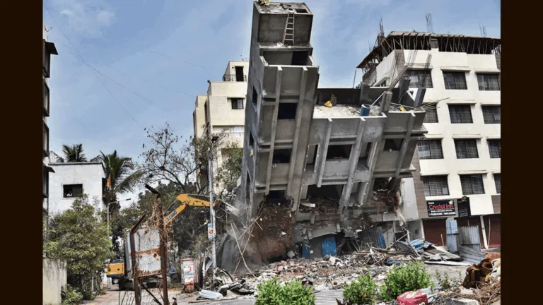 Bulldozer demolishing illegal building in Pune's PCMC area with homebuyers watching in concern, warning of real estate risks.