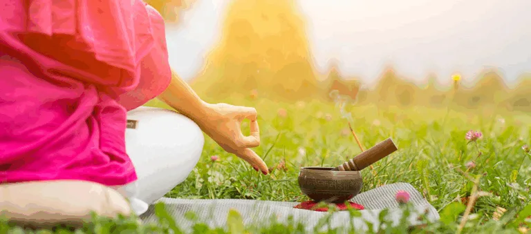 A flat-lay of Well Health Organic Ayurveda products including herbal tea, face oil, and Ayurvedic supplements on a wooden background with a leafy backdrop.