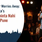 Spotlighted stand-up comedian performing on stage with a microphone and laughing audience in an intimate comedy club, featuring overlay text “Laugh Your Worries Away: Ravi Gupta’s ‘Kal Ki Chinta Nahi Karta’ in Pune” and puneripages.in branding.