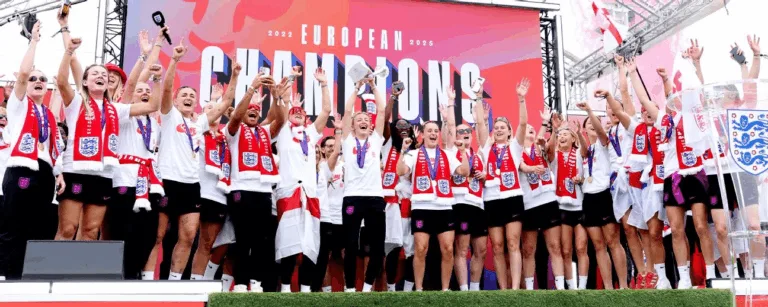 England football team lifting Euro 2025 trophy in Berlin with confetti and fans celebrating