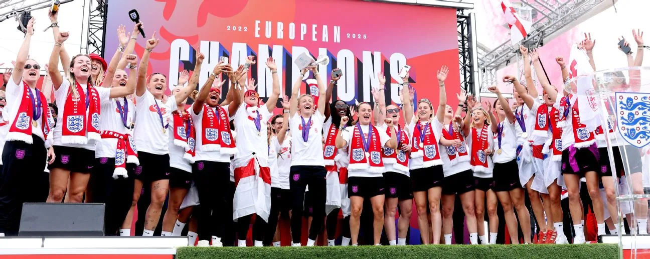 England football team lifting Euro 2025 trophy in Berlin with confetti and fans celebrating