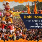 A human pyramid forming to break the dahi handi during Pune's vibrant Dahi Handi festival in 2025, with crowds cheering in the background.