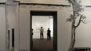 Visitors in an art gallery with artworks on the walls