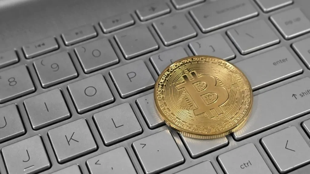 Bitcoin coin on a laptop keyboard, illustrating the Binance crypto hack