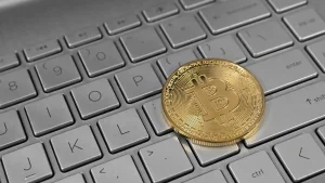 Bitcoin coin on a laptop keyboard, illustrating the Binance crypto hack