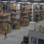 Racks of goods inside a warehouse, representing FDA checks on expired food stock