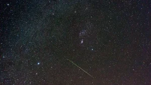 Meteor streaking across a starry night sky during the Leonid meteor shower