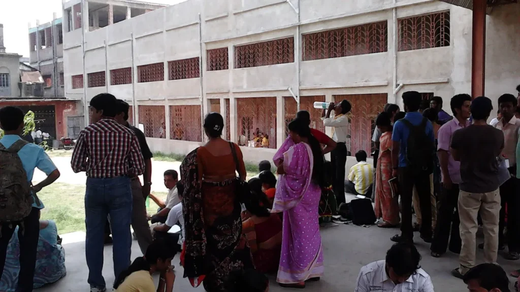 Candidates waiting outside an exam centre in India