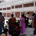 Candidates waiting outside an exam centre in India