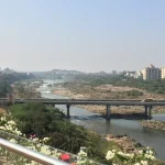 View over Pune city from the riverside on a hazy October day