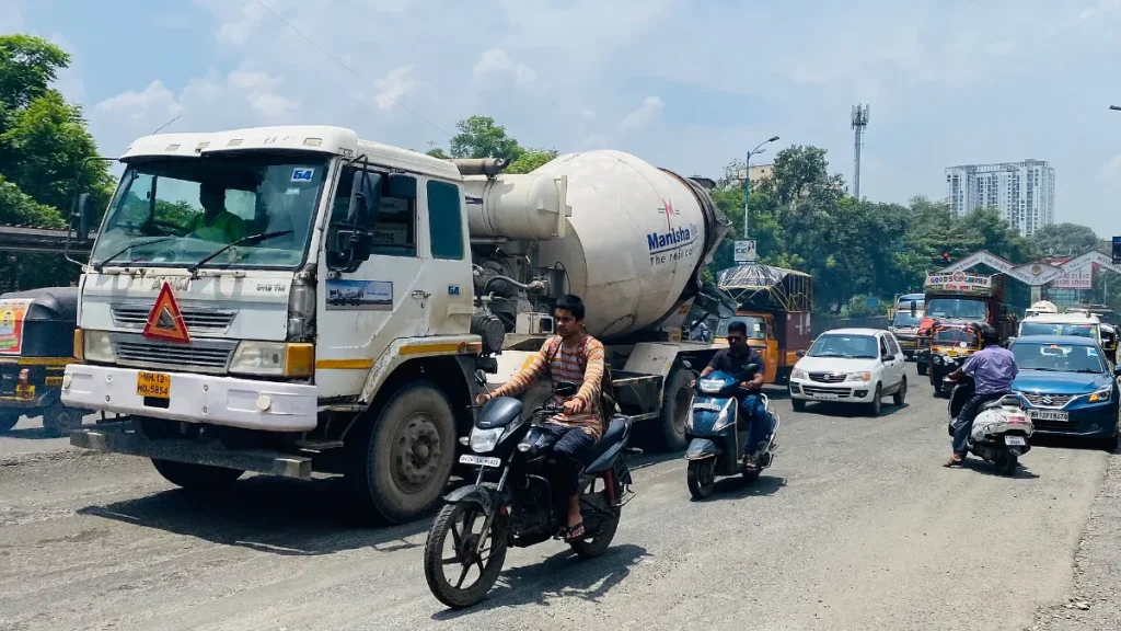 Vehicles and two-wheelers on a busy road in Pune