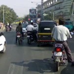 Vehicles in traffic at a signal on Nagar Road, Pune