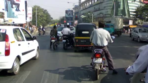 Vehicles in traffic at a signal on Nagar Road, Pune