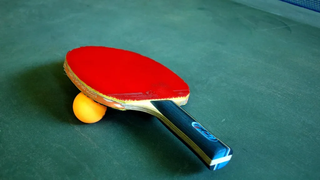 Table tennis bat and ball on a table
