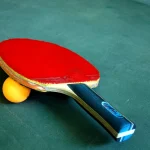 Table tennis bat and ball on a table